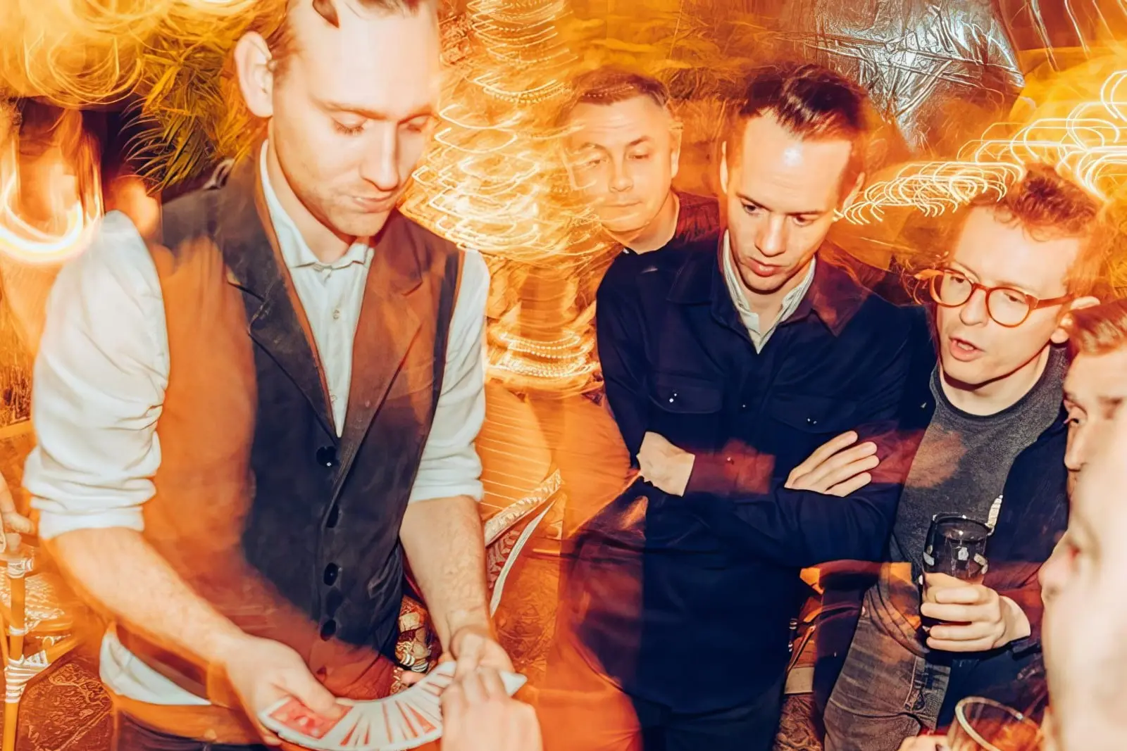 Jack Thomson performing close-up magic to an engaged group